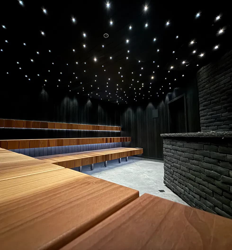 Starlight sauna at Pyramid Of Wellness with cedar benches, brick heater, and fibre optic star ceiling