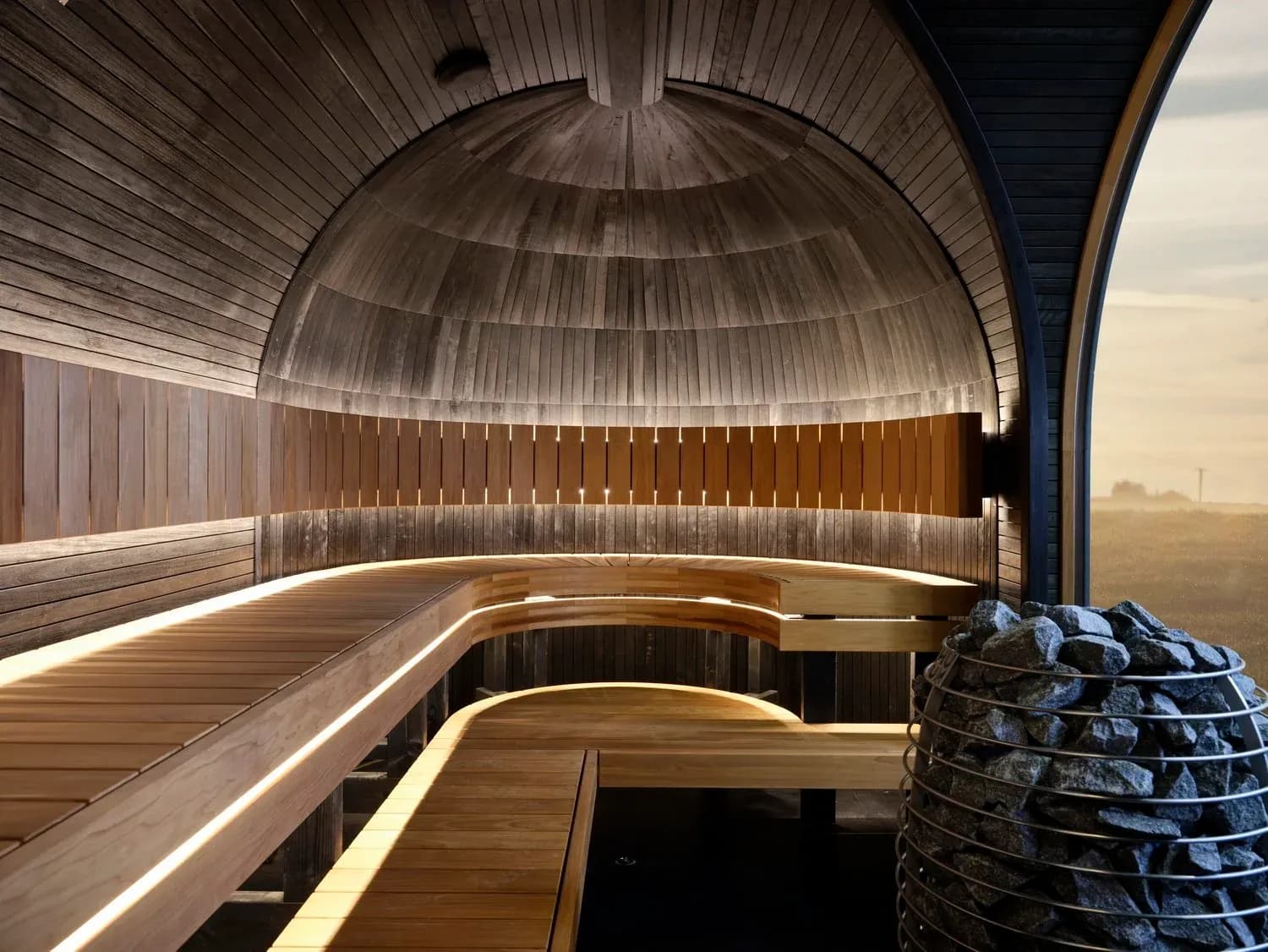 Interior of an Iglucraft panoramic sauna with curved wooden benches and a large window