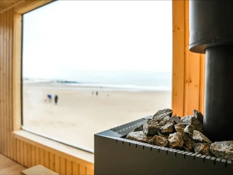Wood-fired sauna heater with panoramic beach view at Steam and Salt, Tynemouth