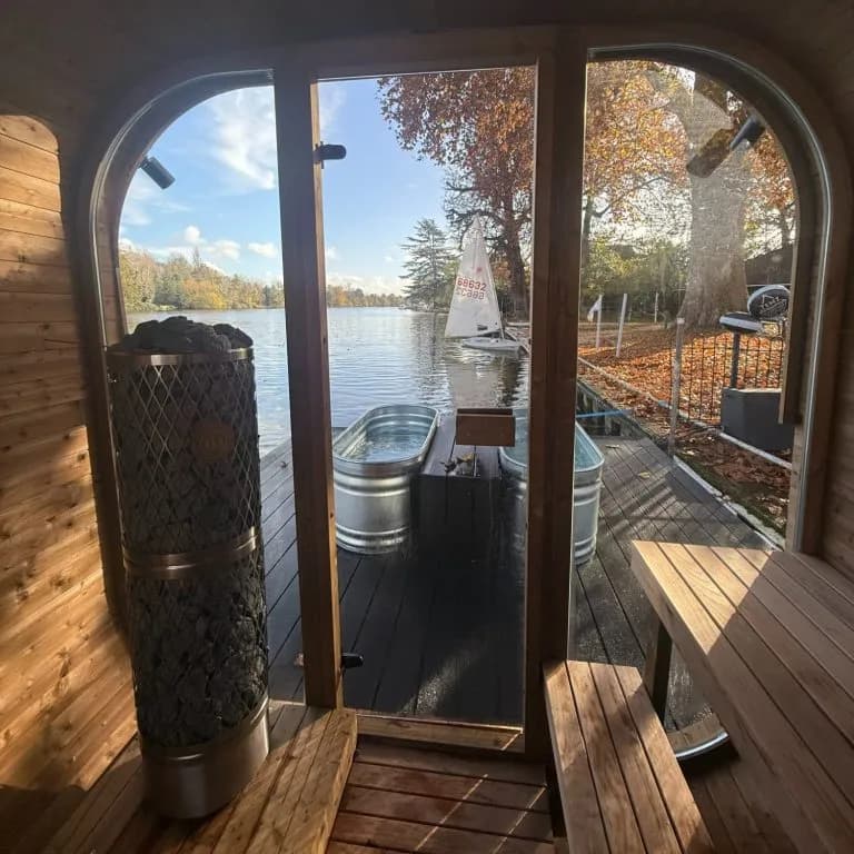 Inside the TEMZ floating sauna with heater, ice bath on the pontoon, and Thames river views