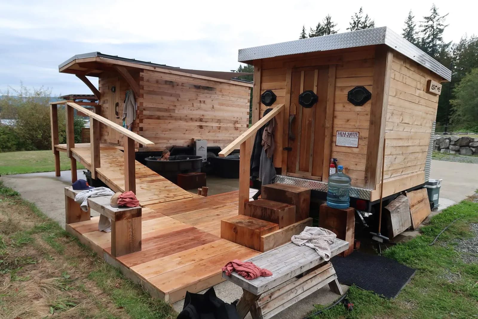 Cedar Porthole Sauna and wood-fired Lake View Sauna on a deck at Sproat Lake Landing