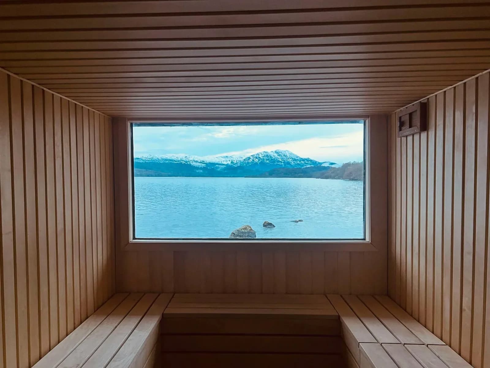 Venachar Lochside sauna interior with wooden benches and loch views through large window