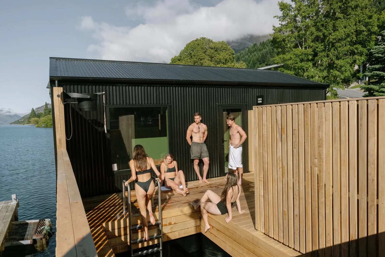 Watershed Saunas floating pontoon on Lake Wakatipu with mountains in the background